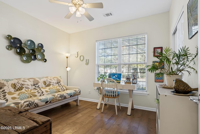 home office with ceiling fan, wood finished floors, visible vents, and baseboards