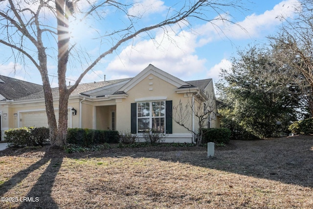 view of front of house featuring a garage and stucco siding