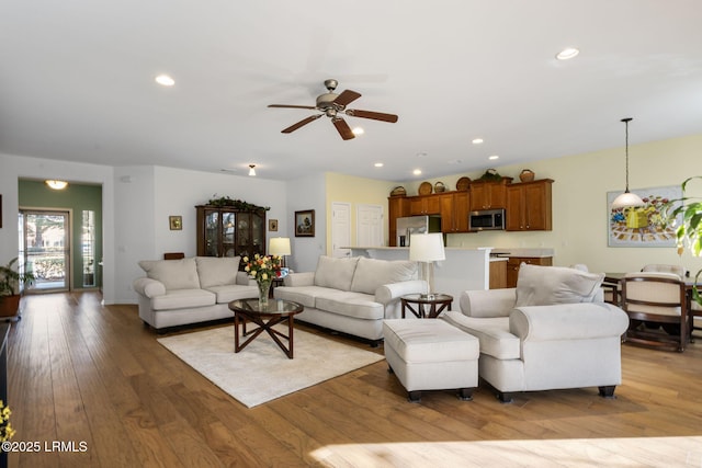 living room featuring ceiling fan, hardwood / wood-style floors, and recessed lighting