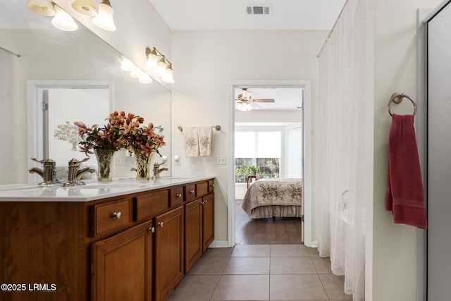 full bath featuring visible vents, baseboards, ensuite bathroom, tile patterned flooring, and vanity