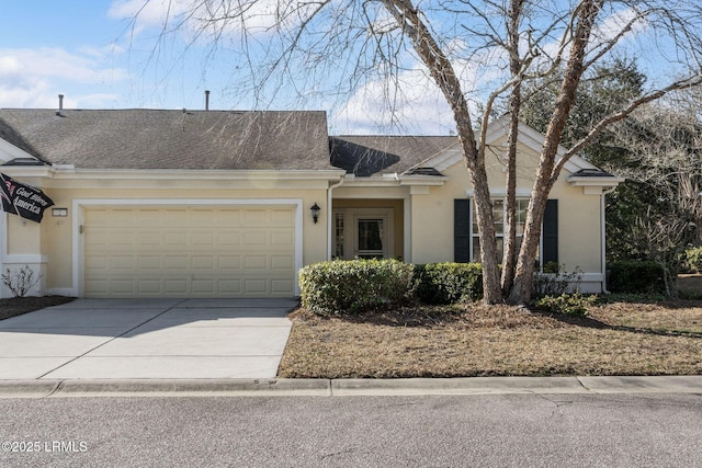 single story home with a garage, concrete driveway, a shingled roof, and stucco siding