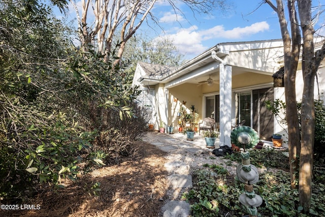 exterior space featuring a ceiling fan and a patio