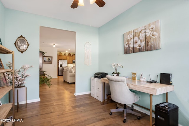 office with light wood-style floors, baseboards, and a ceiling fan