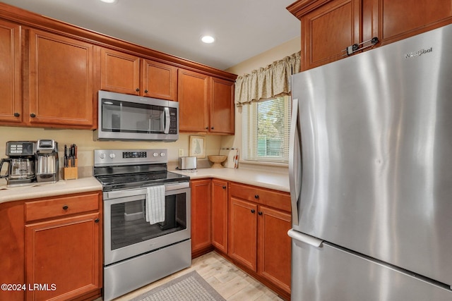 kitchen featuring appliances with stainless steel finishes and light wood-type flooring