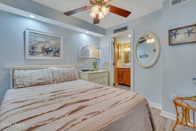 bedroom with ensuite bathroom, ceiling fan, and light hardwood / wood-style flooring