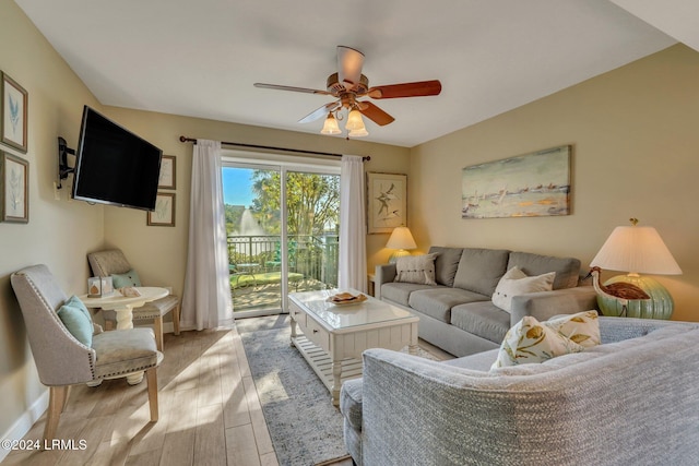 living room with ceiling fan and light hardwood / wood-style flooring