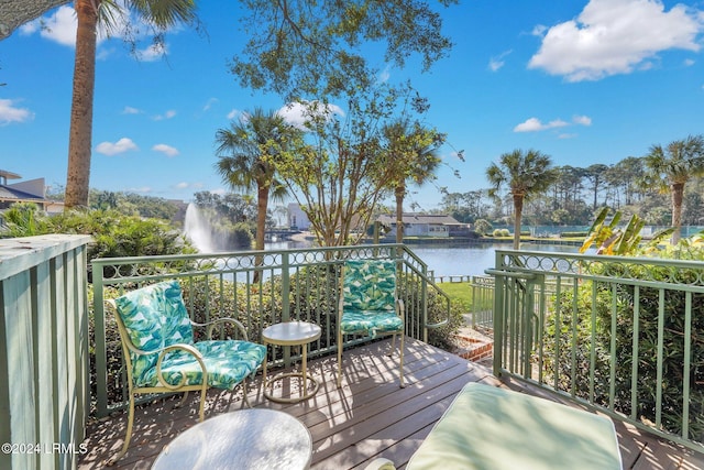 wooden terrace featuring a water view