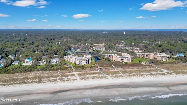 birds eye view of property with a water view and a beach view