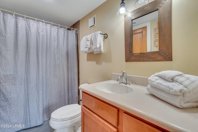 bathroom with vanity, a shower with shower curtain, and toilet