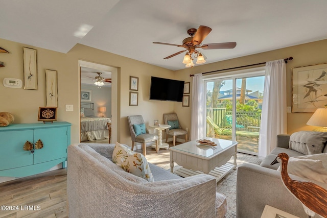 living room featuring ceiling fan and light wood-type flooring