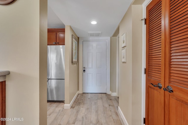 corridor with light hardwood / wood-style flooring