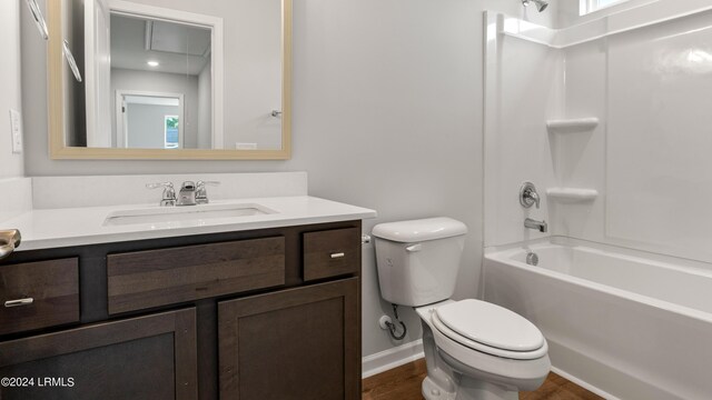 full bathroom featuring vanity, hardwood / wood-style flooring, tub / shower combination, and toilet