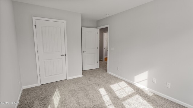 unfurnished bedroom with light carpet