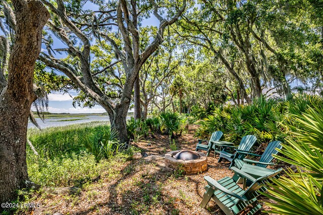 view of yard with a water view and an outdoor fire pit