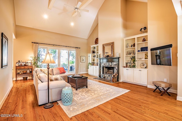 living room with ceiling fan, light hardwood / wood-style floors, and high vaulted ceiling