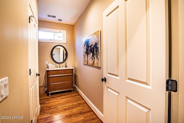 hallway with dark hardwood / wood-style floors and sink