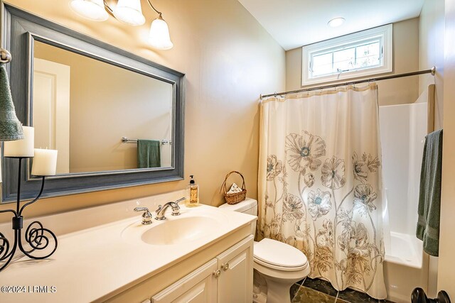 full bathroom with vanity, toilet, and shower / bath combo with shower curtain