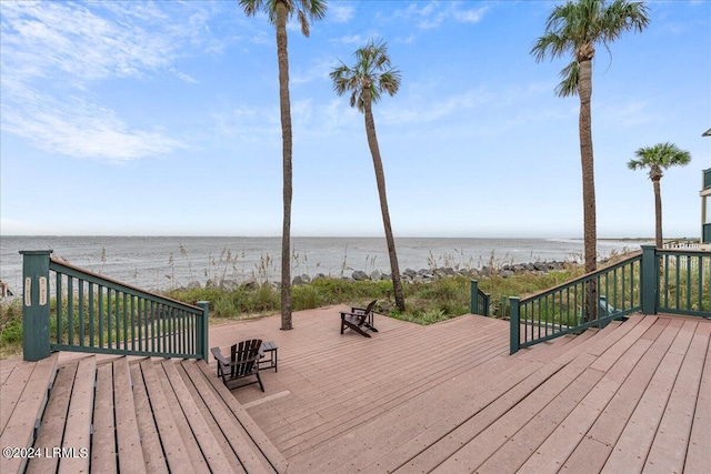 wooden terrace featuring a water view