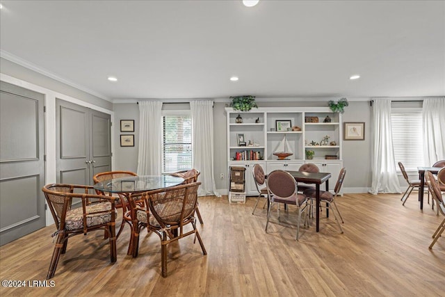 dining room featuring crown molding and light wood-type flooring