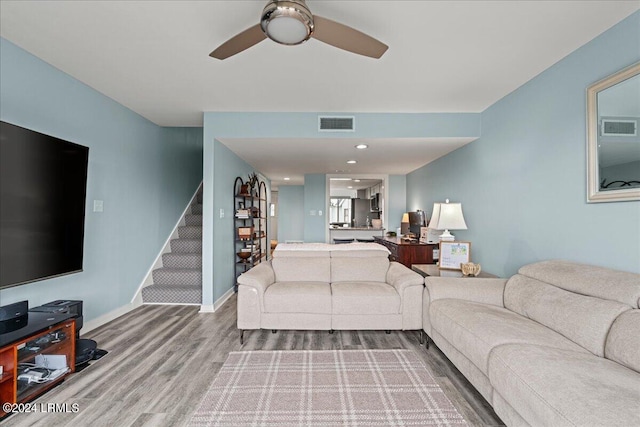 living room with ceiling fan and hardwood / wood-style floors