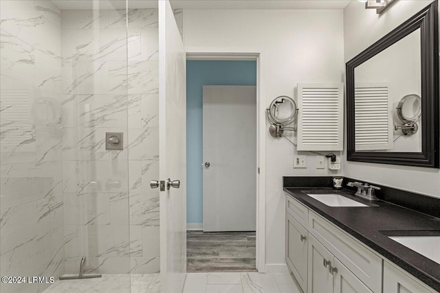 bathroom featuring vanity, tiled shower, and radiator