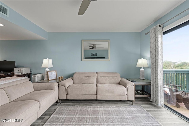 living room featuring ceiling fan and wood-type flooring