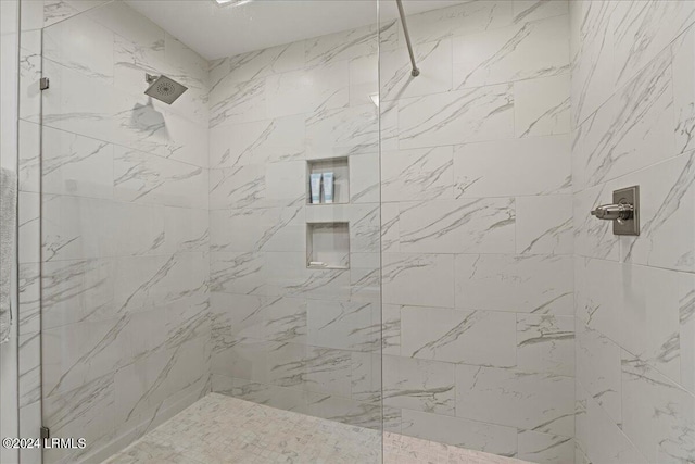 bathroom with tiled shower