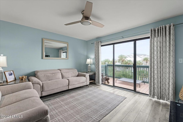 living room featuring ceiling fan and light hardwood / wood-style floors