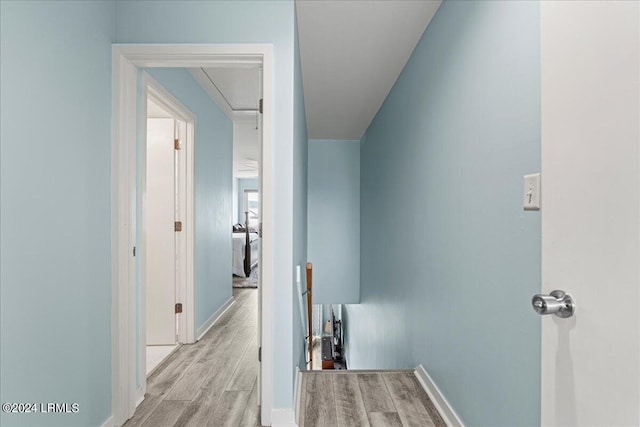 hallway with light hardwood / wood-style flooring