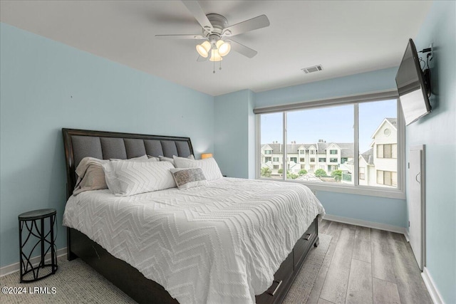 bedroom with wood-type flooring and ceiling fan