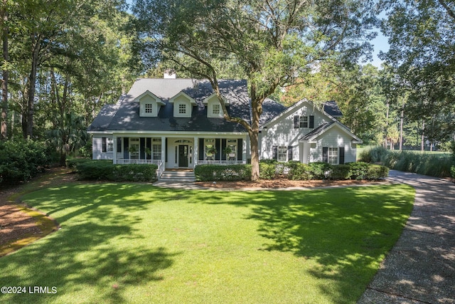 cape cod-style house with covered porch and a front lawn