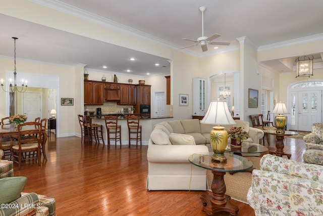 34 Osprey Cir, Okatie, SC 29909 - living room featuring ceiling fan with notable chandelier, ornamental molding, and hardwood / wood-style floors