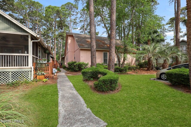53 Salt Marsh Dr, Hilton Head Island, SC 29926 - view of front of home with a front yard and a sunroom