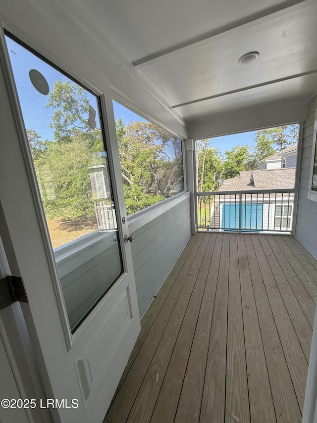 unfurnished sunroom with plenty of natural light