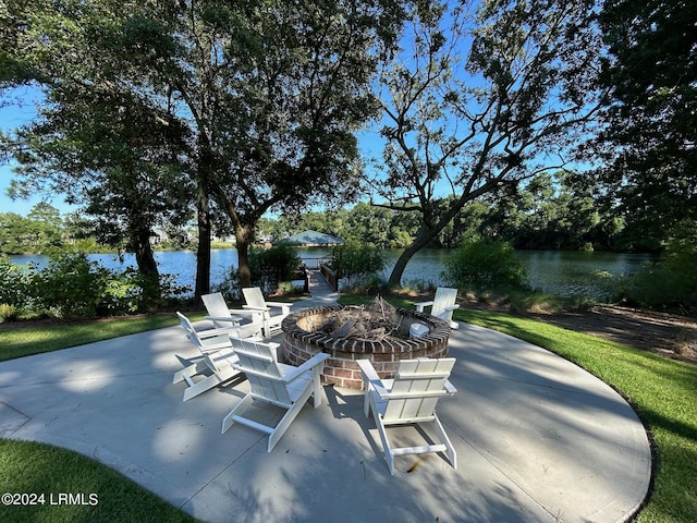 view of patio featuring an outdoor fire pit and a water view