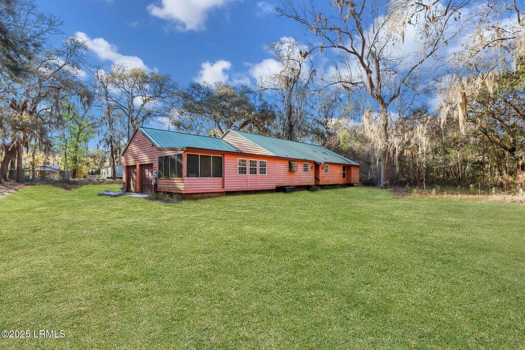 view of property exterior with a garage and a yard