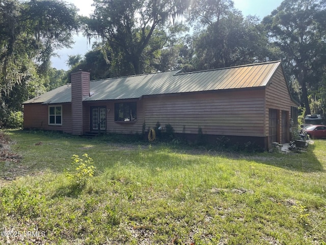 view of property exterior with a garage and a yard