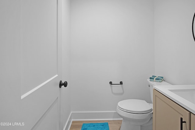 329 S St, Bluffton, SC 29910 - bathroom with vanity, hardwood / wood-style flooring, and toilet