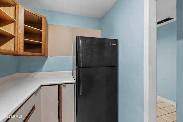 2304 Pine Ct S Unit 1, Beaufort, SC 29902 - kitchen featuring freestanding refrigerator, light tile patterned floors, light countertops, and open shelves