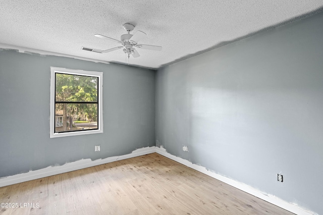 2304 Pine Ct S Unit 1, Beaufort, SC 29902 - empty room with a textured ceiling, wood finished floors, ceiling fan, and baseboards