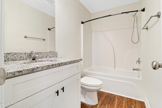 full bathroom with vanity, hardwood / wood-style flooring, shower / bathtub combination, and toilet