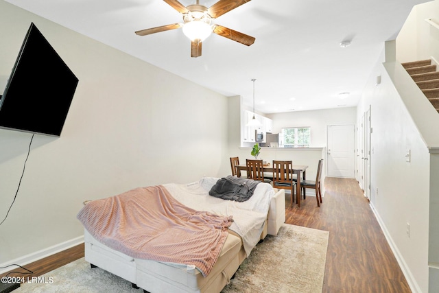 bedroom featuring hardwood / wood-style floors and ceiling fan