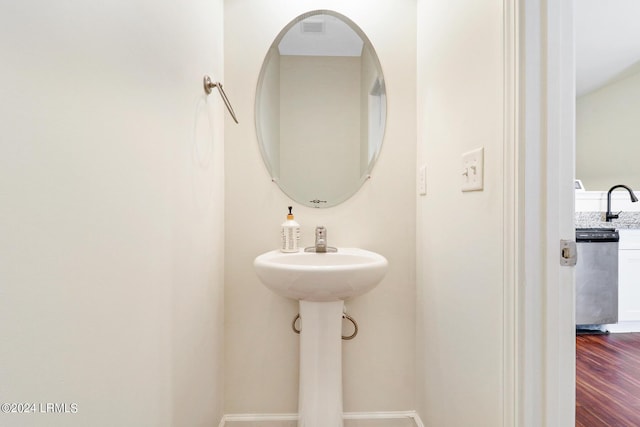 bathroom with sink and hardwood / wood-style floors