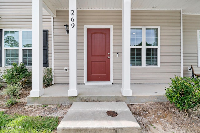 view of exterior entry with a porch