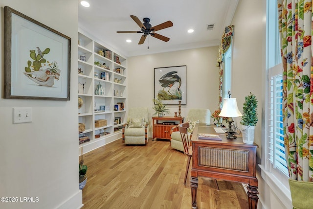 sitting room with wood finished floors, visible vents, recessed lighting, ornamental molding, and ceiling fan