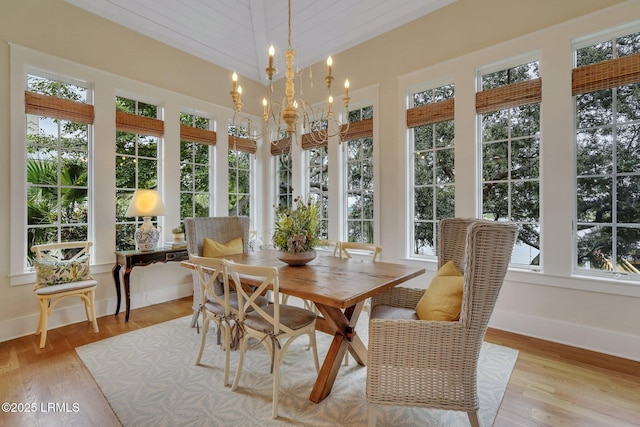 sunroom / solarium featuring a wealth of natural light and a notable chandelier