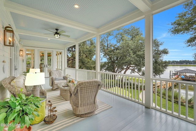 sunroom featuring french doors, beam ceiling, ceiling fan, and a water view