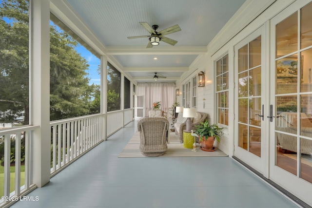 unfurnished sunroom with beam ceiling, coffered ceiling, and ceiling fan