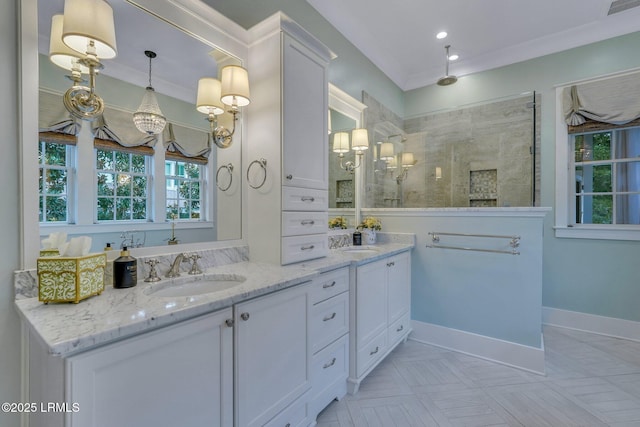 bathroom with a sink, walk in shower, ornamental molding, and double vanity