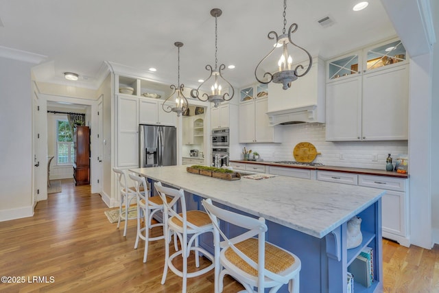 kitchen with visible vents, open shelves, stainless steel appliances, white cabinets, and light wood finished floors